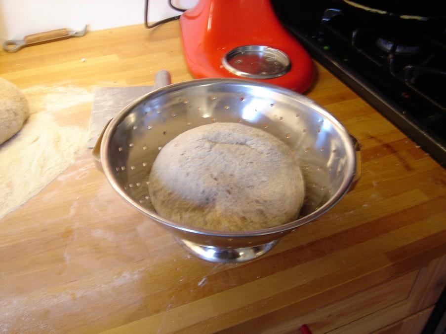 the dough should look like the picture above. When the first rise is complete, turn out the dough onto a flour-covered counter and divide it into three lumps or patties of equal weight.