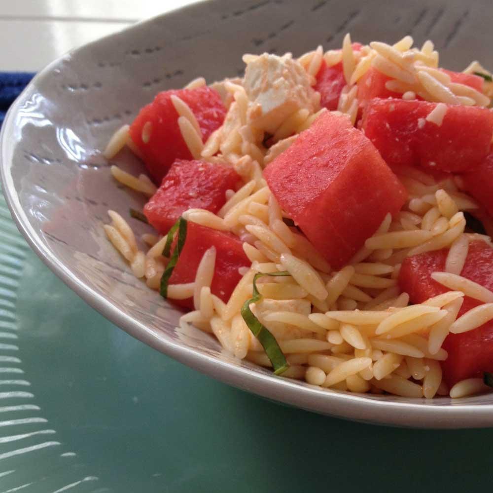 Watermelon Feta Salad : 1 C Uncooked Orzo 1 T Olive Oil 2 C Watermelon, cut into 1/2 inch cubes 4 ounces Feta, Cut into small cubes 2 T Mint, Sliced Thin 2 T Basil, Sliced Thin 1.