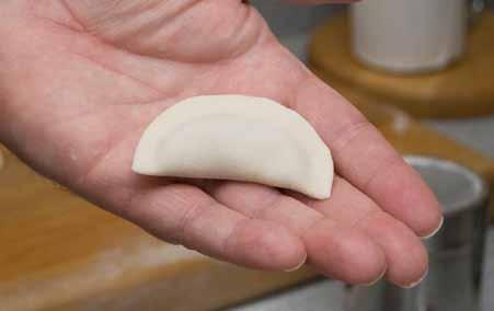 Pinch all the way to the fold on both ends, making sure the dumpling is sealed all the way around.