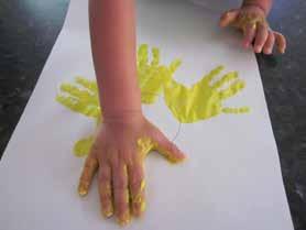 SUNFLOWER LAB Handprint Sunflower Art Materials Yellow Paint Green Paint Sheet of Paper Glue Brown or Black Crayons Pour yellow paint onto a plate, so the children can completely cover their hands in