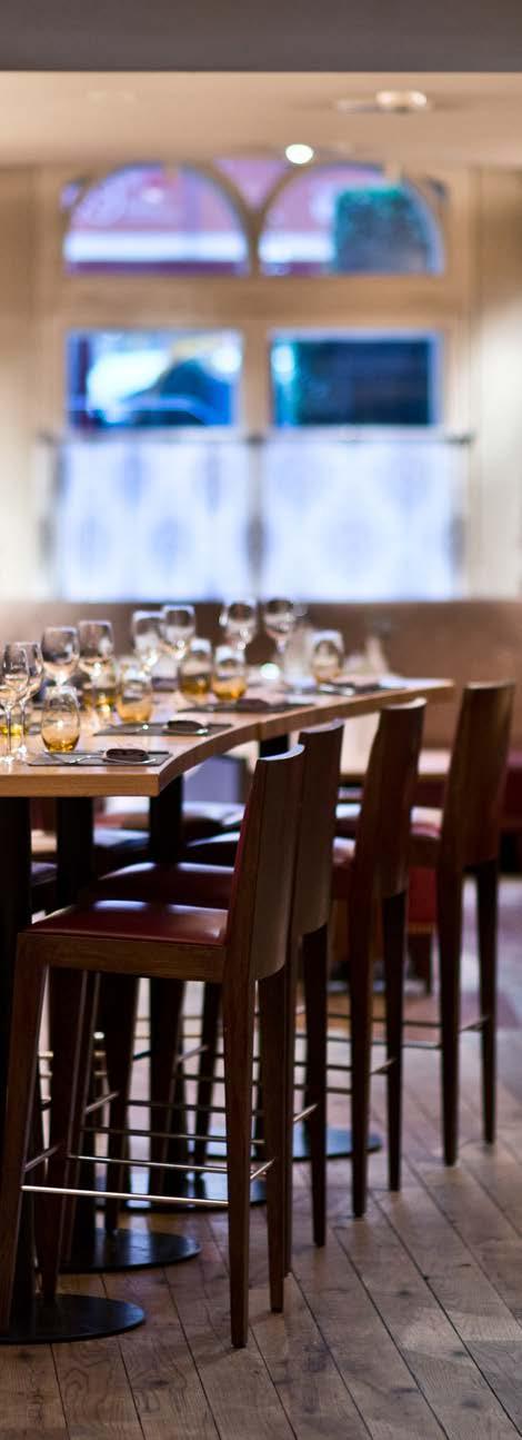 HIGH TABLE LOCATED NEXT TO THE LOUNGE AREA, THE HIGH TABLE CAN SEAT UP TO 11 GUESTS ON A RECTANGULAR SHAPED TABLE WITH STOOLS, IDEAL FOR SMALL GROUPS WISHING TO FEEL THE FULL ATMOSPHERE OF BAR BOULUD