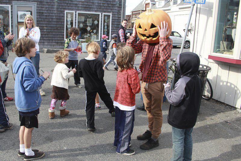 Vincenzo Dimino/File photo/children gather around the Scarecrow after catching him in the Scarecrow Chase Costume Parade at last year's Rockport Harvestfest. This year's HarvestFest is 10 a.m. to 5 p.