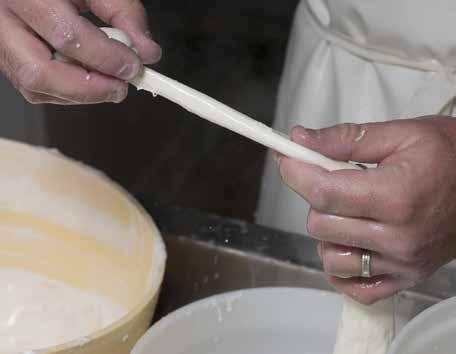 Ladle curds into a colander, folding them together gently toward the center and draining off the whey as you go. 9b.