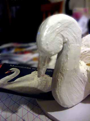 Attach the Swan Head & Neck to the Gingerbread Bowl: First, take your cake board, or whatever you are going to use to put your Swan on, and lay down some Royal Icing and then place the Gingerbread
