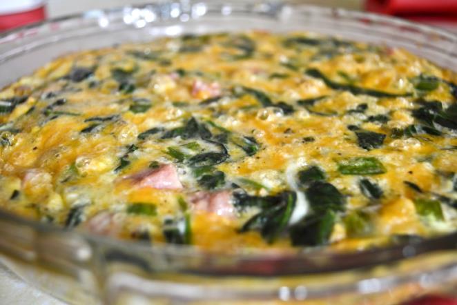 Crustless Quiche butter 1 tbs vegetable oil 1 onion, chopped 1 (10 oz) package frozen chopped spinach, thawed and drained 5 eggs, beaten 3 cups shredded cheese (cheddar, muenster, swiss, etc.
