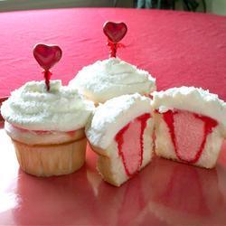 Valentine Cupcakes 1 (18.25 ounce) package white cake mix 1 1/4 cups water 1/3 cup vegetable oil 3 egg whites 8 drops red food coloring Preheat an oven to 350 degrees F.