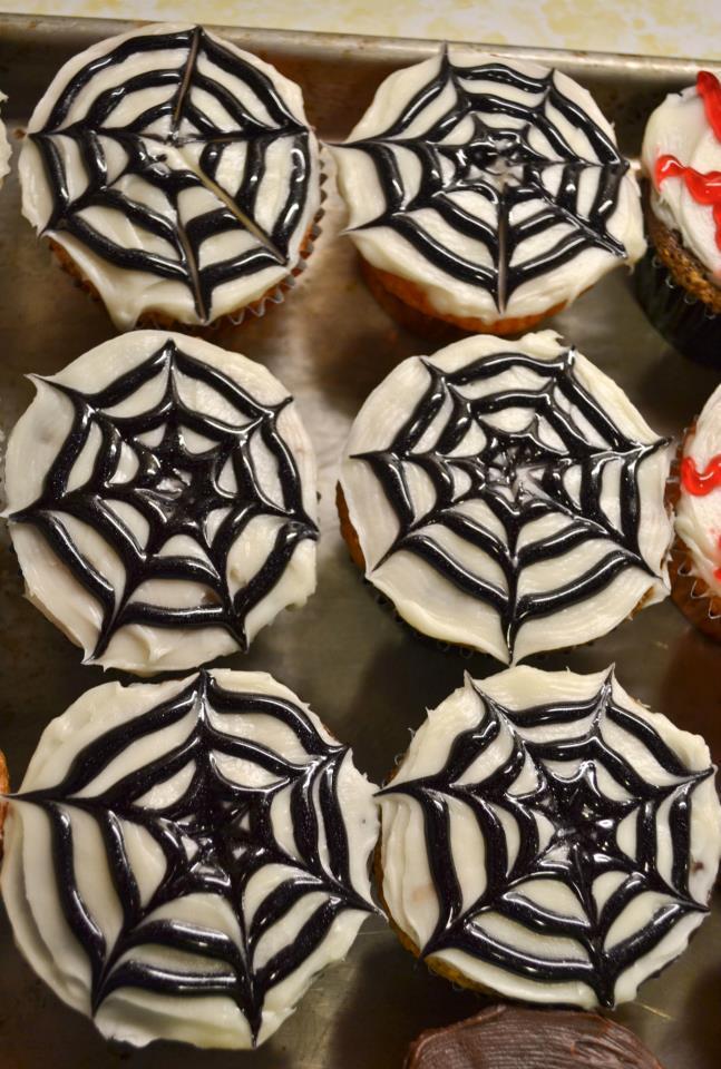 Spiderweb Cupcakes Frost cupcakes with white icing.