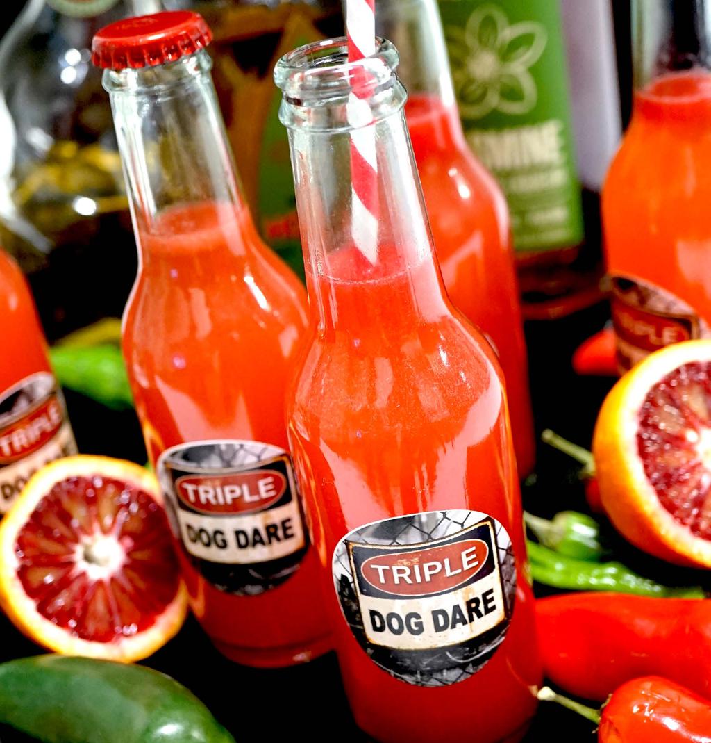 TRIPLE DOG DARE PREMIUM TEQUILA AND ORGANIC LIQUEUR, BLOOD ORANGE, AND A TRIPLE DOG DARE OF THREE PEPPERS.
