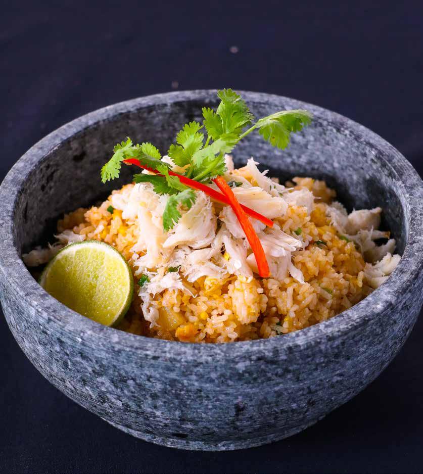 CRAB AND PINEAPPLE FRIED RICE Fragrant rice tossed with special crab paste, cut pineapple, topped with