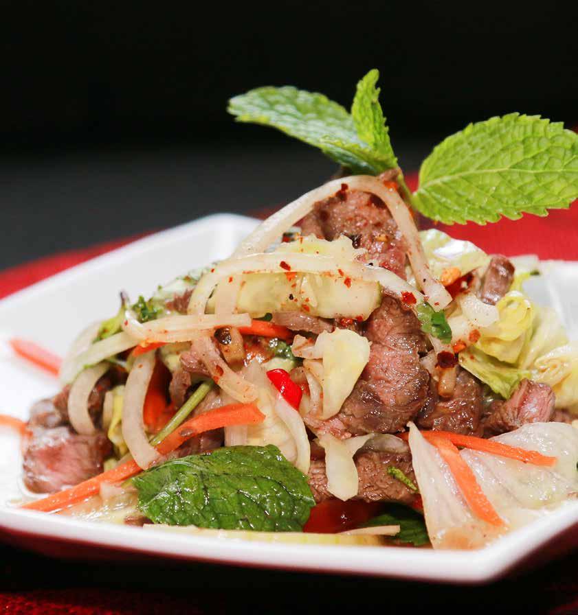 Australian beef salad (BÒ tái chanh) Prime beef tossed with fresh tomatoes and onions in a full-flavoured dressing and served on a bed of fresh garden greens.