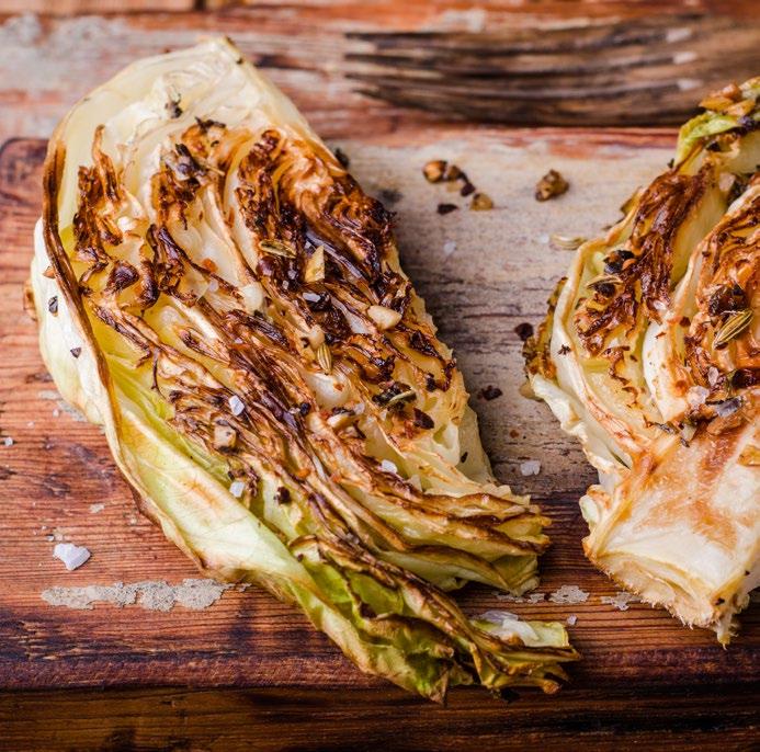 Roasted Cabbage with Herb Sauce 1 head of green cabbage 2 tablespoons coconut oil, melted Sea salt, pepper, granulated garlic ¼ cup salted almond butter ¼ cup water Juice of ½ a lemon 2 tablespoon