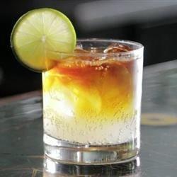 dash in bitters. Garnish the glass with a lime wedge on the lip.