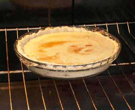 14 After the pie shell cooks for 10 minutes, remove it from the oven, reduce the oven temperature to 350 F (175 C).