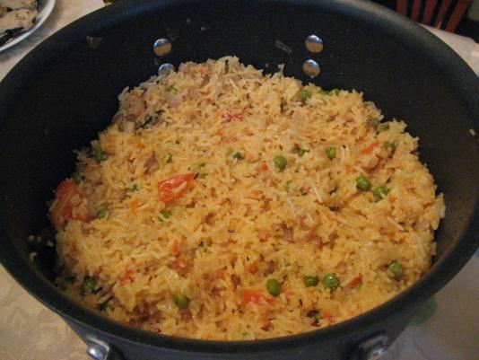 Stir well with salt Add equal amounts of water-stock so that it covers up the rice with a ½ inch additional. Add peas. Cook on slow flame periodically stirring. Eat hot.