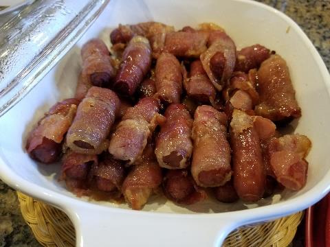 slices bacon, cut into 3 strips 1/4 cup maple syrup 1/4 cup brown sugar 1/2 teaspoon cayenne wrap mini hot dogs in bacon.