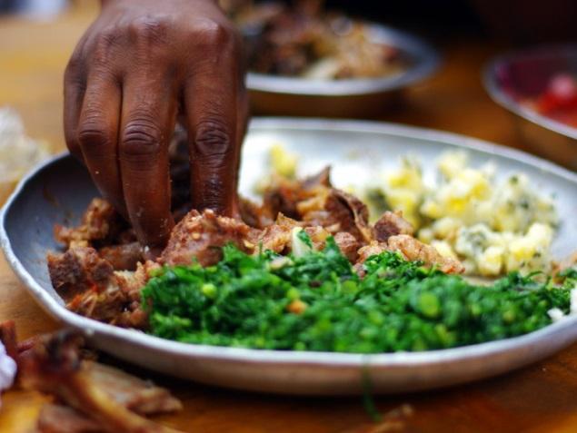 Nyama choma is always eaten with the hands, and common side dishes include kachumbari salad and ugali.