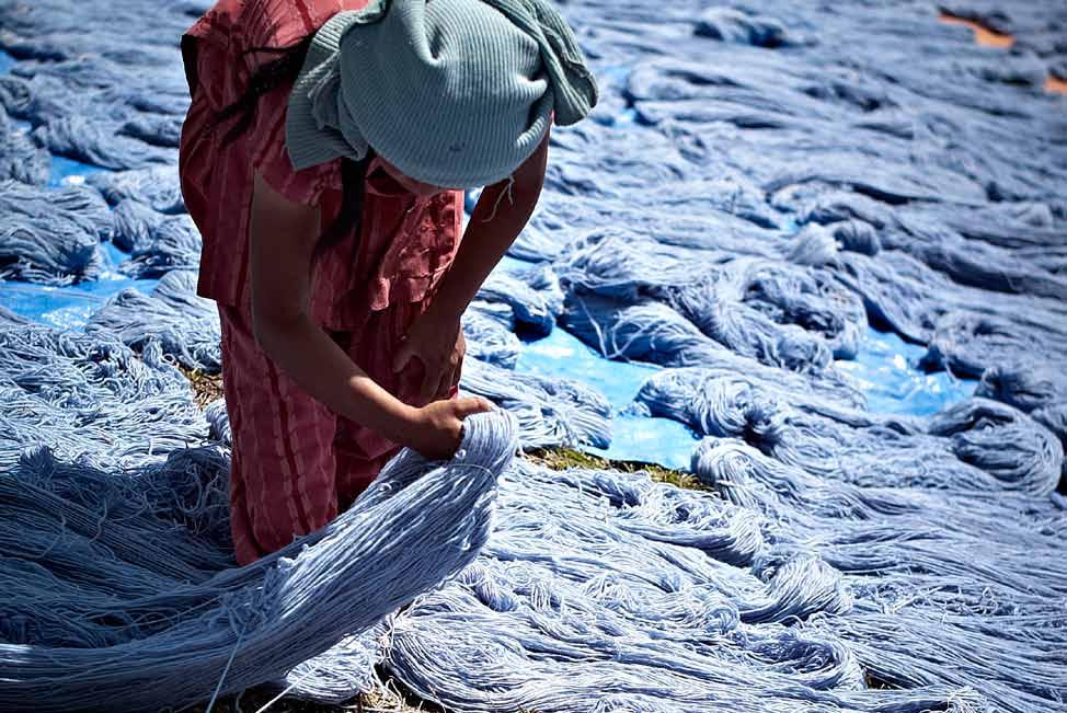 Sea of Blue Sterling blue #23 drying under the sun. Credit: Eric Lajeunesse In Bhaktapur, Nepal, a worker tends to wool drying under the sun.