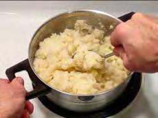 potatoes into a serving bowl with a big