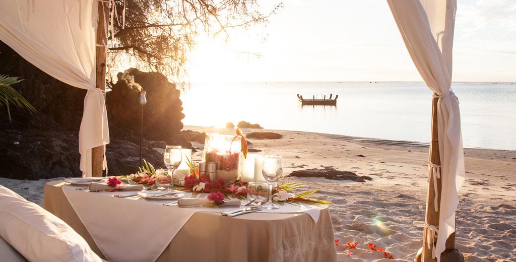 ROMANTIC DINING FROM $150 + Food and Beverage Premium set up $150 Table and chairs on the beach or on your private balcony, white tablecloth, personal barefoot waiter and scattered leaves Superior