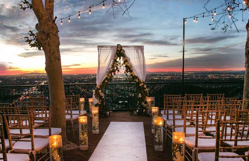 Courtesy of Happy Photos Ceremony Package Located on our North or South Patio Overlooking Orange County Seating Accommodations for up to 150 Guests Arch Valet Parking White Ceremony Chairs