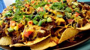 Starters nachos Corn tortilla chips made in house loaded with sweet bell peppers, garlic tomatoes, red onions and oven baked with a 3 cheese blend. Served with sour cream, salsa and shredded lettuce.