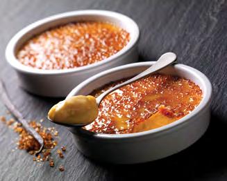CRÈME BRÛLÉE IN RAMEKIN A creamy custard presented in a traditional ceramic ramekin, comes with a packet of sugar.