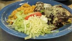 guacamole. Burrito "El patron" $9.99 A flour tortilla with seasoned ground beef or chicken. Topped with lettuce, sour cream & tomatoes. Served with rice and beans.