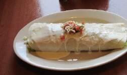 Burritos Rancheros $10.99 Two shredded beef burritos, topped with cheese, lettuce, tomatoes & sour cream. Served with rice, beans & nacho sauce.