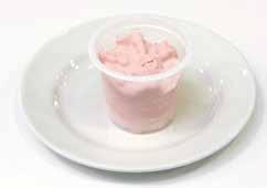 A vanilla flavour iced dessert with strawberry sauce swirls.