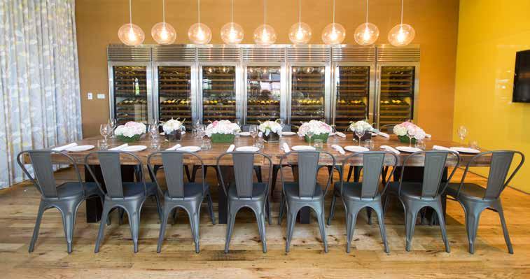 Seven sub-zero wine cases line the back wall and enclosed in floor-toceiling glass walls on two sides with curtains that can remain open to the dining room.