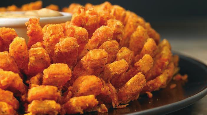 BLOOMIN' ONION AUSSIE-TIZERS S BLOOMIN' ONION An Outback Ab-Original! Our special onion is hand-carved, cooked until golden and ready to dip into our spicy signature bloom sauce. 9.