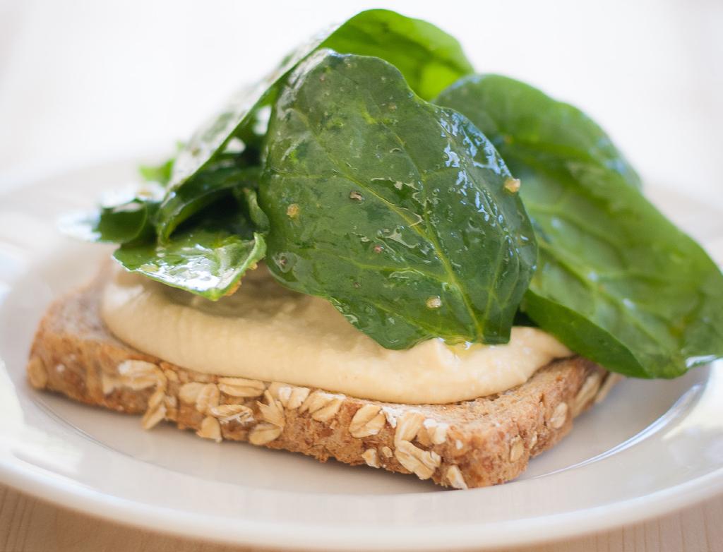 EAT MORE, BURN MORE HUMMUS AND SPINACH CROSTINI Active time: 5 minutes Cook time: N/A Yield: 2 serving SERVING INFO: 140 CALORIES, 5G FAT, 19G CARBOHYDRATES, 6G PROTEIN, 5G FIBER, 1G SUGAR 2 slices