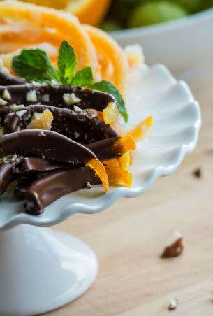 Candied Orange Peels Dessert oranges cups sugar ¾ cup water Melted dark chocolate Chopped almonds Peel the oranges and cut the peels in ¼ inch strips, being sure to get as little pith as possible.