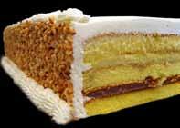 Italian Rum Cake: Sponge cake soaked in rum flavor, layered with vanilla and chocolate creams iced in buttercream and surrounded in peanuts.