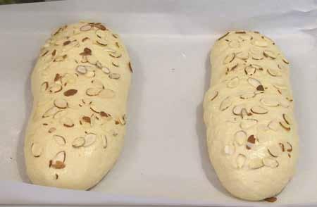 9 6 Arranged sliced almonds on top. Cover the loaves lightly with plastic wrap and let rise until doubled, 30 to 45 minutes.