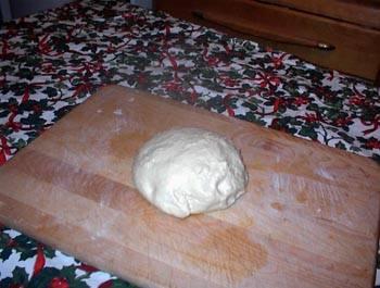 6. Knead slightly and pat into a round. Lightly brush top of dough with cooking oil. (Not olive oil.