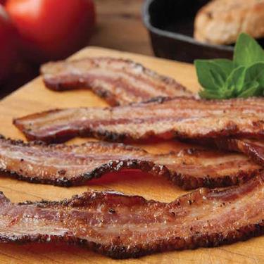 BACON Irresistible scent of crispy bacon frying in a pan.