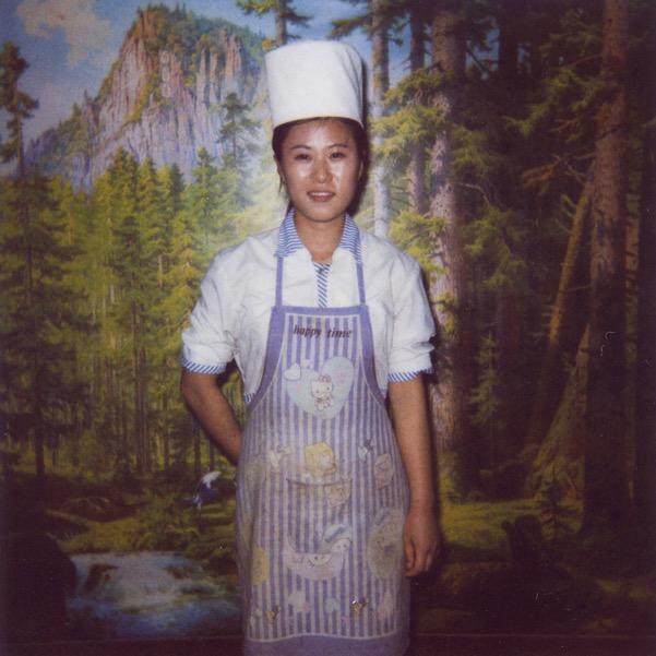 A cook in a restaurant in Pyongyang with a Hello Kitty apron.