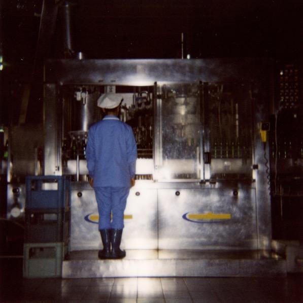 A woman working in the mineral water factory of Nampo. The guide was so proud to show us this factory, because President Mitterand made a visit here before he was elected in France.