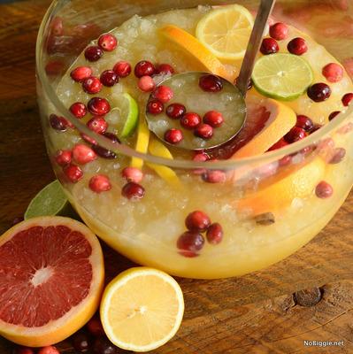 JINGLE JUICE 1 /3 can Piña Colada Concentrate 1/3 can Lemonade Concentrate 1/3 can Orange Juice Concentrate 1 liter Club Soda 1 red grapefruit (sliced) 1 navel orange (sliced) 1 lime (sliced) 1 lemon