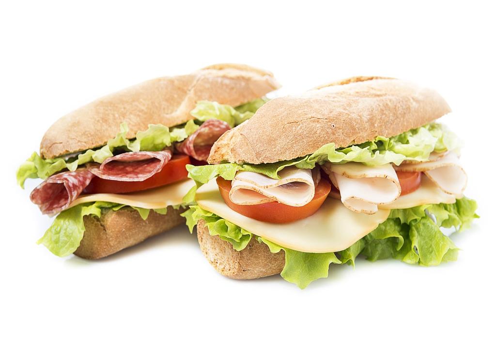 Platter of assorted deli sandwiches of ham & cheese, turkey & cheese, tuna salad and Italian hero (ham,