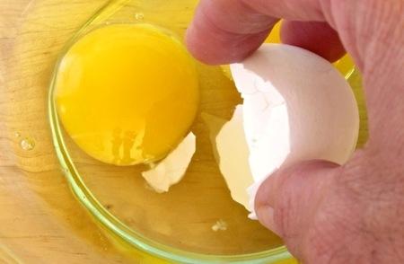 using a larger eggshell piece to attract and scoop up the smaller