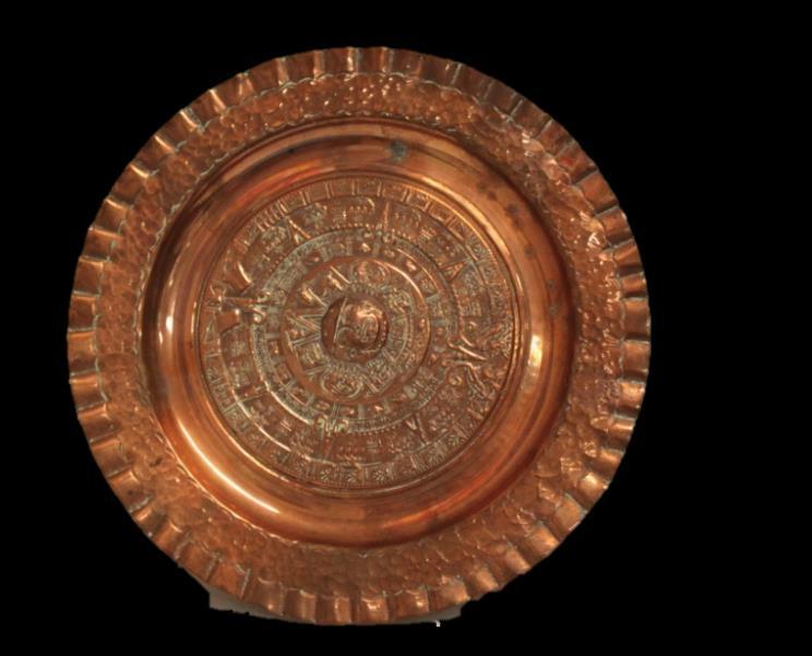 COPPER PLATE This copper plate features the Aztec calendar. This sort of plate is sold in gift shops and can be used as decoration.