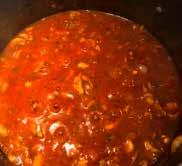 Stir in tomatoes, tomato paste, water, oregano, salt and