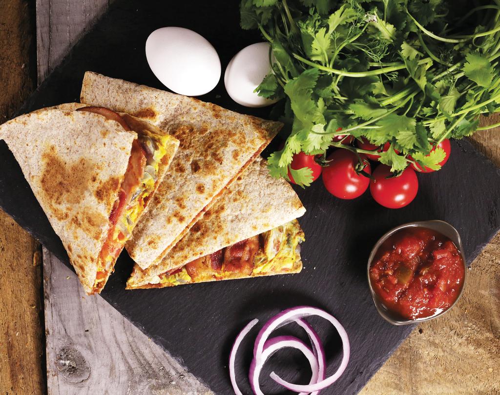 BREAKFAST QUESADILLA Eggs, bacon, ham, Yellow Ribbon cheese, caramelized onions and tomatoes on
