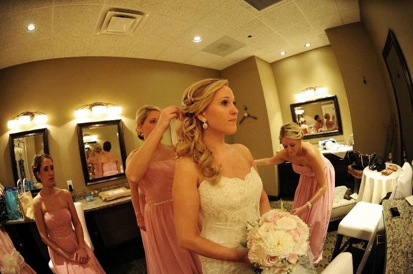 An elegant bridal suite equipped with multiple vanity stations, hooks for dresses & veil,