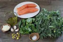 Blend the kale, basil, garlic, olive oil and salt in a food processor. Spoon the mixture onto the salmon. Oven bake the salmon for 30 minutes or until the flesh is a pale pink throughout.