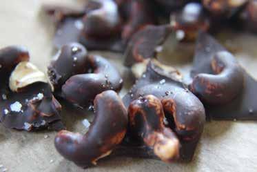 Salted chocolate cashews 80g unsalted cashews ½ tsp coconut oil 35g dark chocolate (minimum 70% cocoa) sprinkle of sea salt flakes SERVES 5 Preheat the oven to 120 C / 250 F.