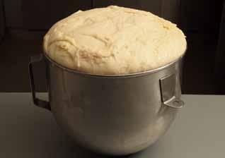 Beat the mixture on a moderate speed with a dough hook until the dough comes away from the side of the bowl, about 12 13