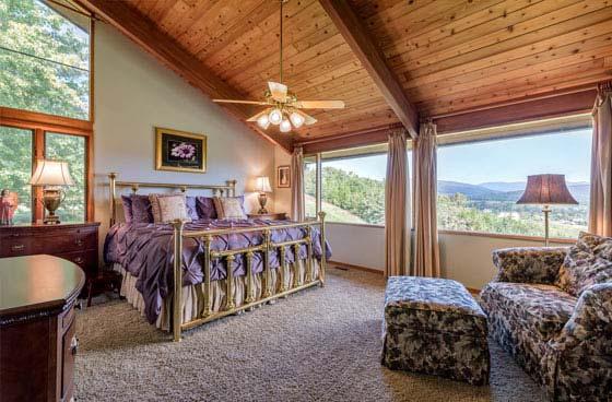 MASTER BEDROOM: 18 X 14 Vaulted cedar planked ceiling Multi-speed ceiling fan Carpeted Windows in two directions Walk-in closet and a second closet 8 panel door MASTER BATH, INCLUDING WALK IN CLOSET: